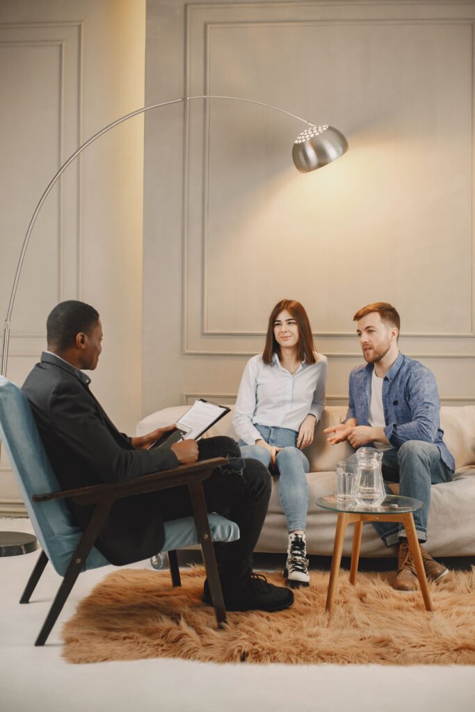Black male therapist leading a counseling session with a couple
