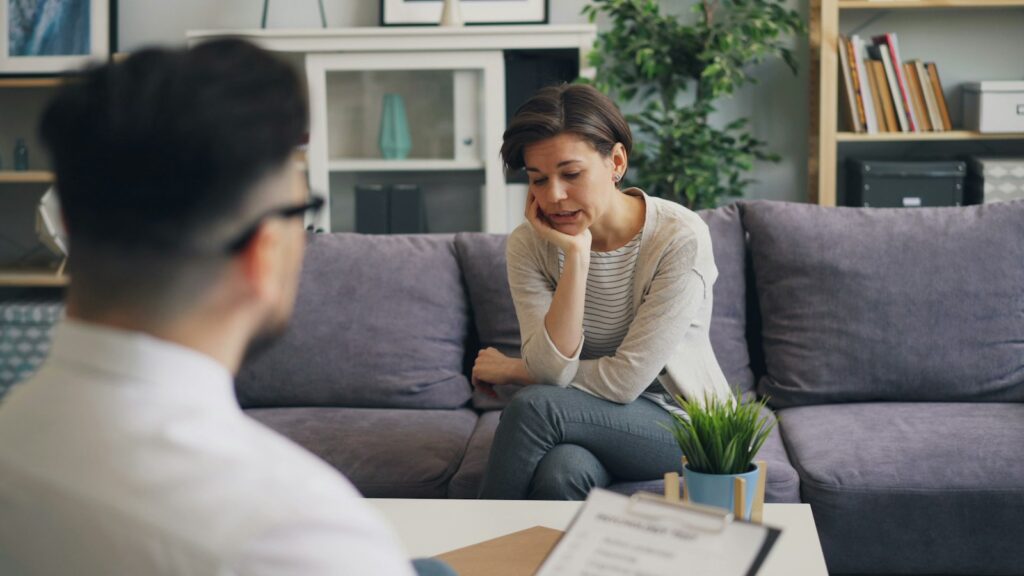 Client talking with a counselor in a calm, comfortable office